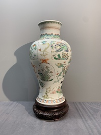 A fine Chinese famille verte 'mythical creatures' vase on a reticulated wooden stand, Kangxi
