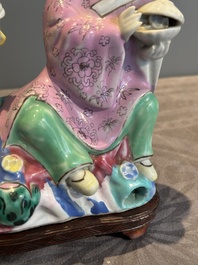 A Chinese famille rose group of Hehe Erxian on wooden stand, Qianlong