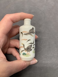Four Chinese famille rose, verte and blue and white snuff bottles, Qianlong mark, 19/20th C.