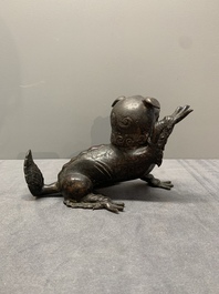 A rare Chinese bronze lion-form incense burner and cover, Song/Ming
