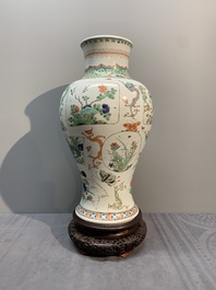 A fine Chinese famille verte 'mythical creatures' vase on a reticulated wooden stand, Kangxi