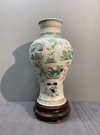 A fine Chinese famille verte 'mythical creatures' vase on a reticulated wooden stand, Kangxi