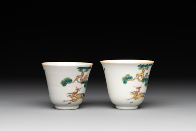 A pair of Chinese famille rose 'monkey and deer' cups and saucers, Tongzhi mark and of the period