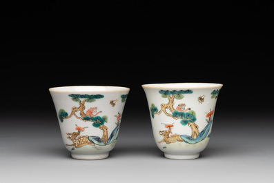 A pair of Chinese famille rose 'monkey and deer' cups and saucers, Tongzhi mark and of the period