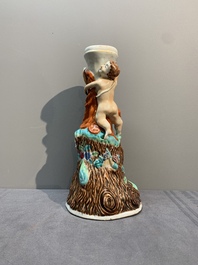 A Chinese export faux-bois stand with two putti and two famille rose boys, Qianlong/Jiaqing