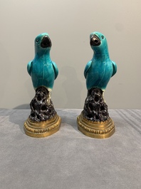 A pair of turquoise- and aubergine-glazed parrots with gilt bronze mounts, Kangxi