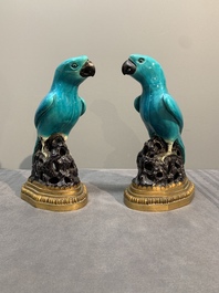 A pair of turquoise- and aubergine-glazed parrots with gilt bronze mounts, Kangxi