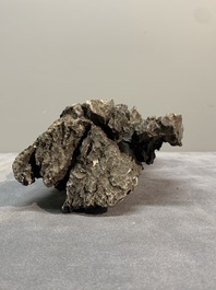 A Chinese ying stone scholar's rock on wooden stand, 20th C.