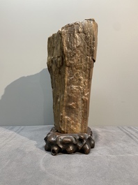 A Chinese petrified wood scholar's rock on wooden stand, 17/18th C.