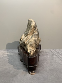 A Chinese Lingbi stone scholar's rock on wooden stand, 20th C.