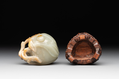 A Chinese jade peach-shaped brush washer on wooden stand, 19th C.
