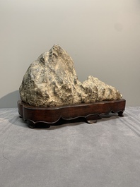 A Chinese Lingbi stone scholar's rock on wooden stand, 20th C.