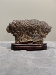 A Chinese grape agate scholar's rock on wooden stand, 20th C.
