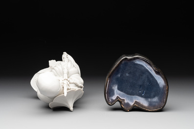 A Chinese Dehua blanc de Chine Luohan on wooden stand, 19/20th C.