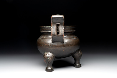 A Chinese bronze tripod censer with two handles, Ming