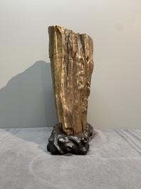 A Chinese petrified wood scholar's rock on wooden stand, 17/18th C.