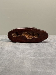 A Chinese grape agate scholar's rock on wooden stand, 20th C.