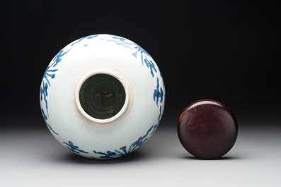 A Chinese blue and white 'lotus scroll' vase with wooden cover, Kangxi