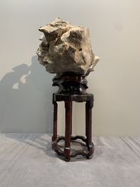 A Chinese Taihu stone scholar's rock on wooden stand, 20th C.