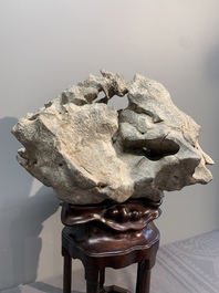 A Chinese Taihu stone scholar's rock on wooden stand, 20th C.