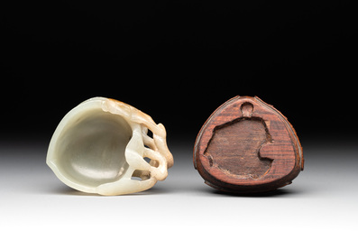 A Chinese jade peach-shaped brush washer on wooden stand, 19th C.