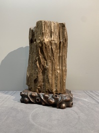 A Chinese petrified wood scholar's rock on wooden stand, 17/18th C.