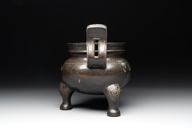 A Chinese bronze tripod censer with two handles, Ming