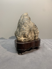 A Chinese Lingbi stone scholar's rock on wooden stand, 20th C.