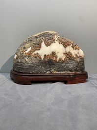 A Chinese wucai Lingbi stone scholar's rock on wooden stand, 20th C.