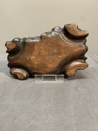 A Chinese petrified wood scholar's rock on wooden stand, 17/18th C.