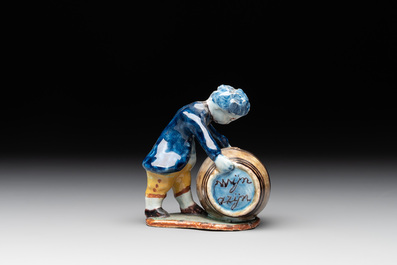 A polychrome Dutch Delft model of a boy rolling a 'wijn azijn' barrel, 18th C.