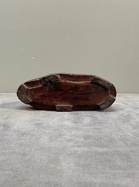 A Chinese grape agate scholar's rock on wooden stand, 20th C.