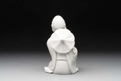A Chinese Dehua blanc de Chine Luohan on wooden stand, 19/20th C.