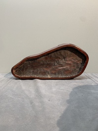 A Chinese wucai Lingbi stone scholar's rock on wooden stand, 20th C.