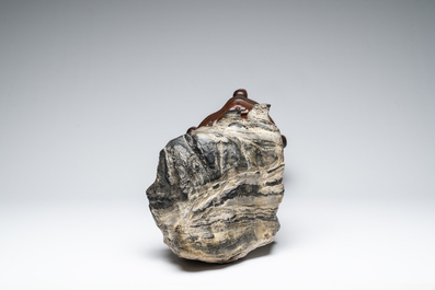 A Chinese green Lingbi stone scholar's rock on wooden stand, 20th C.