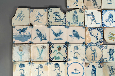 105 polychrome, blue and white Dutch Delft tiles with figures, flowers and animals, 17/18th C.
