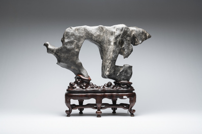 A large Chinese Lingbi stone scholar's rock on wooden stand, 19/20th C.