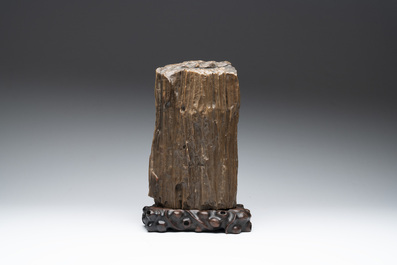 A Chinese petrified wood scholar's rock on wooden stand, 17/18th C.