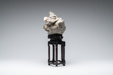 A Chinese Taihu stone scholar's rock on wooden stand, 20th C.