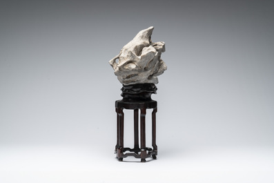 A Chinese Taihu stone scholar's rock on wooden stand, 20th C.