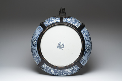 A massive Chinese blue and white reverse-decorated  'dragon' charger with bronze mounts, Chuxiu Gong Zhi mark, Guangxu