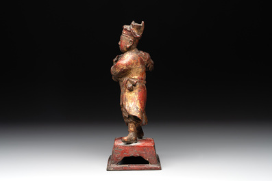 A Chinese gilt-lacquered bronze offering figure on stand, Ming