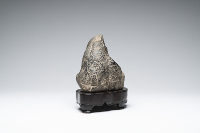 A Chinese Lingbi stone scholar's rock on wooden stand, 20th C.
