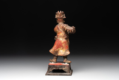 A Chinese gilt-lacquered bronze offering figure on stand, Ming