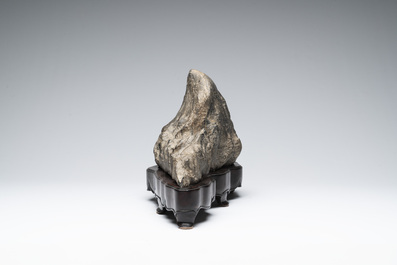 A Chinese Lingbi stone scholar's rock on wooden stand, 20th C.