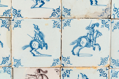 20 manganese, blue and white Dutch Delft tiles with horse riders and putti, 17th C.
