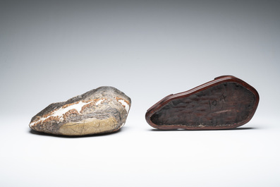A Chinese wucai Lingbi stone scholar's rock on wooden stand, 20th C.