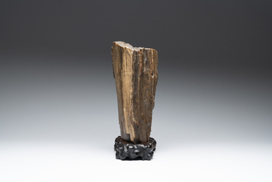 A Chinese petrified wood scholar's rock on wooden stand, 17/18th C.