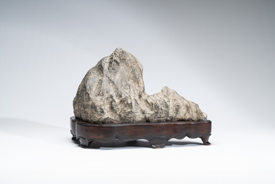 A Chinese Lingbi stone scholar's rock on wooden stand, 20th C.
