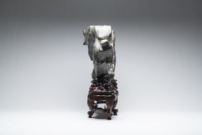 A large Chinese Lingbi stone scholar's rock on wooden stand, 19/20th C.